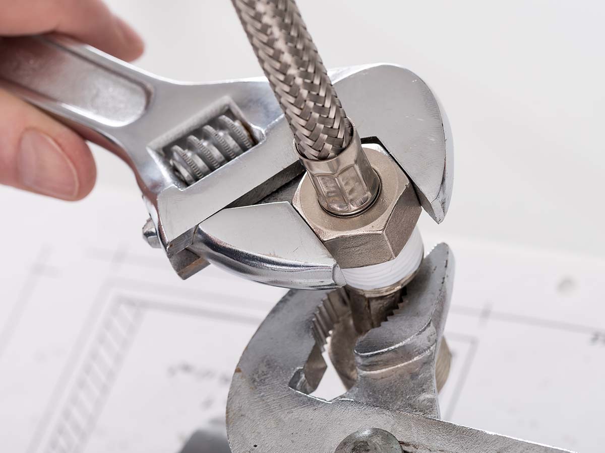 A plumber working on a fitting.