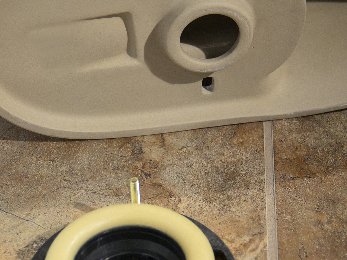A toilet base and wax ring