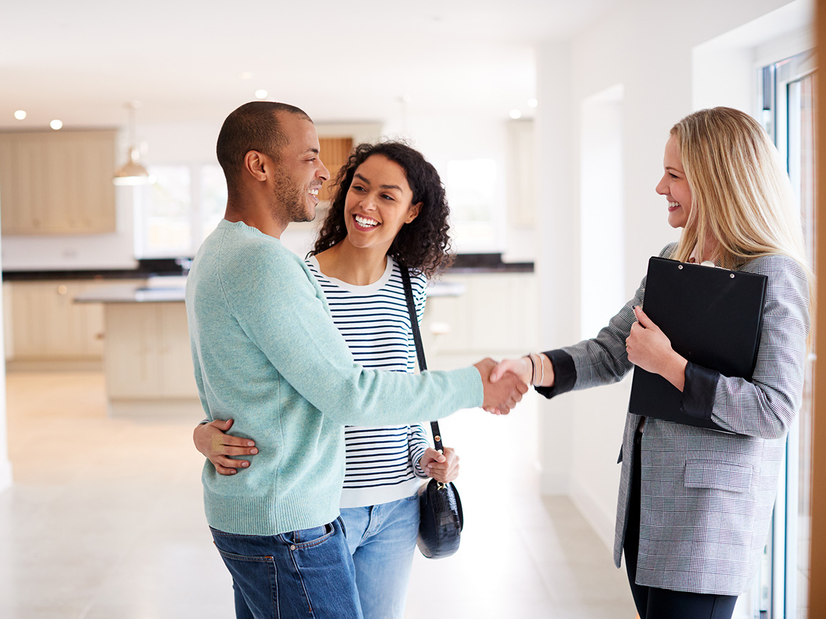 A young couple talking with a realtor