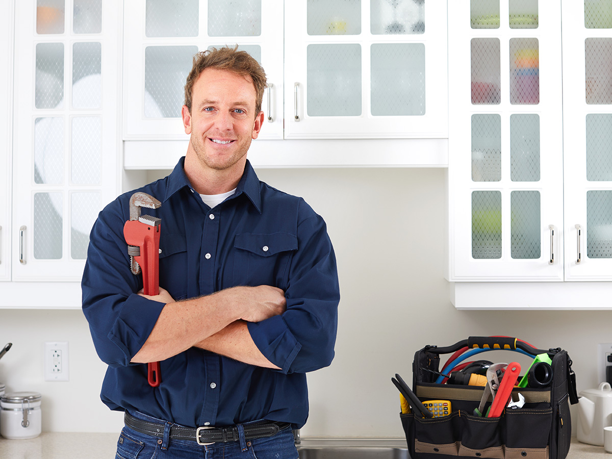 A professional plumber with his tools