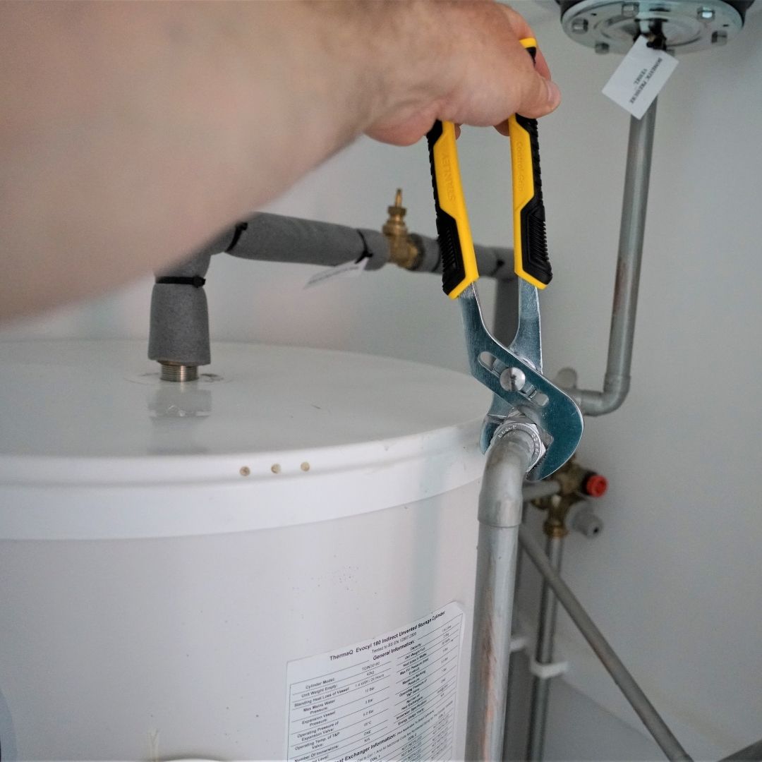 plumber working on water heater