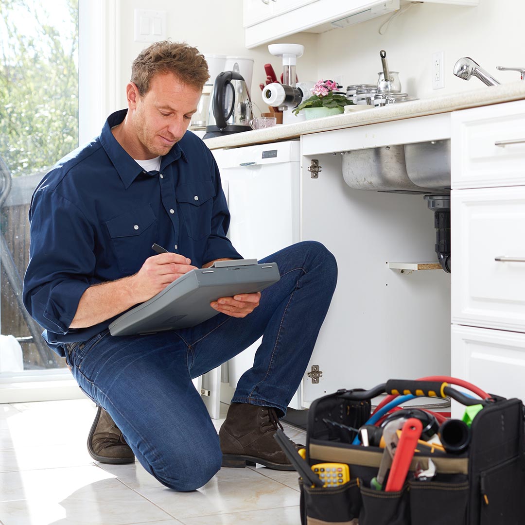 Plumber looking writing on a clipboard