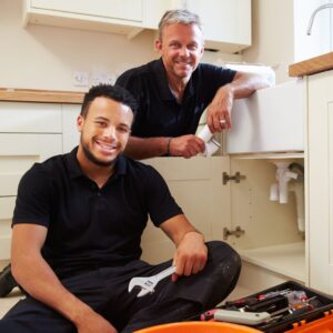 two smiling plumbers
