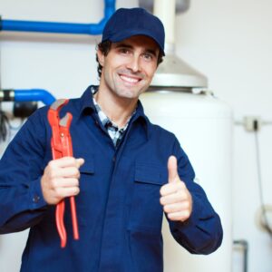 plumber smiling and holding wrench