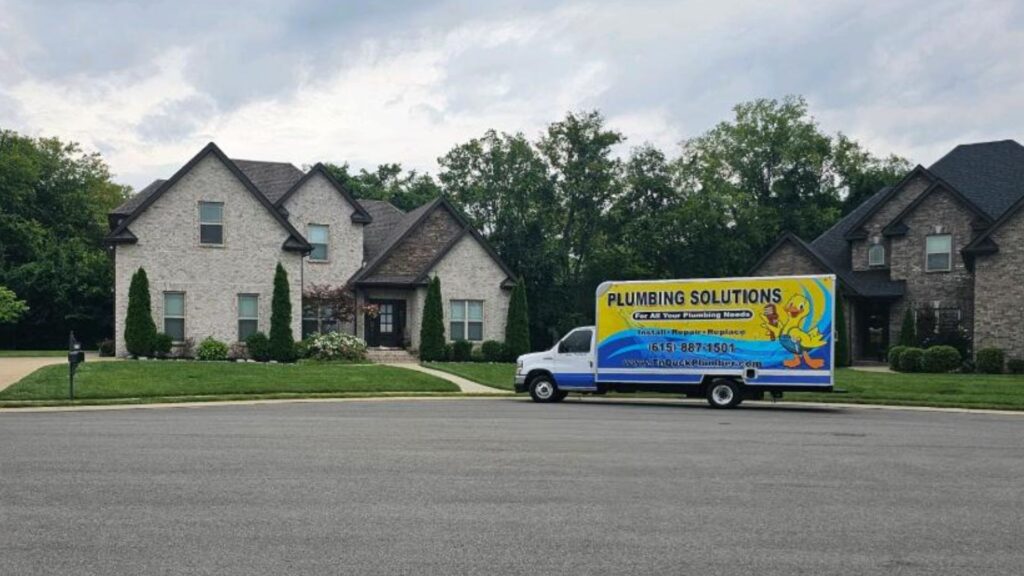 Plumbing Solutions truck outside of a home