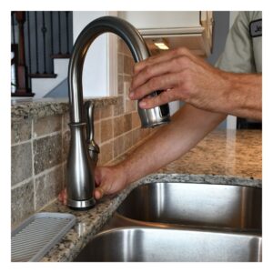 plumber checking for a leaky faucet