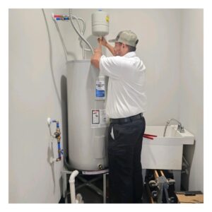 plumber working on water heater repairs