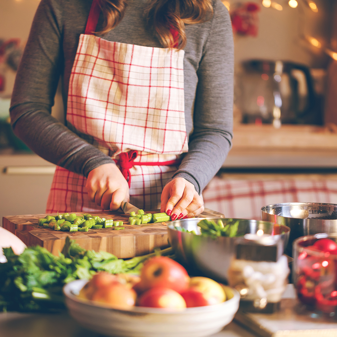 Young Woman Cooking in the kitchen. Healthy Food for Christmas (stuffed duck or Goose)