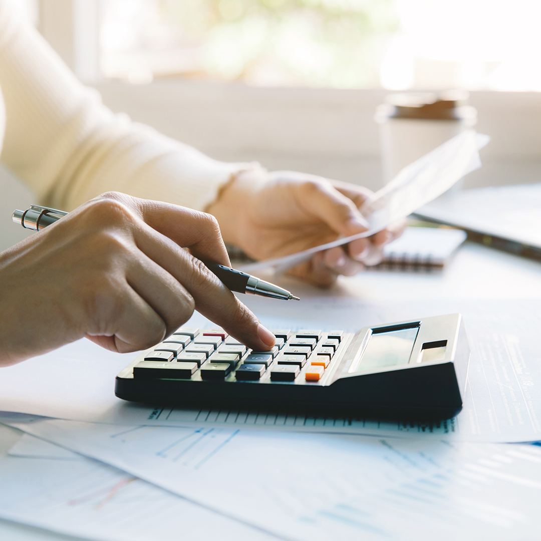 women calculate domestic bills at home. using calculator at mode
