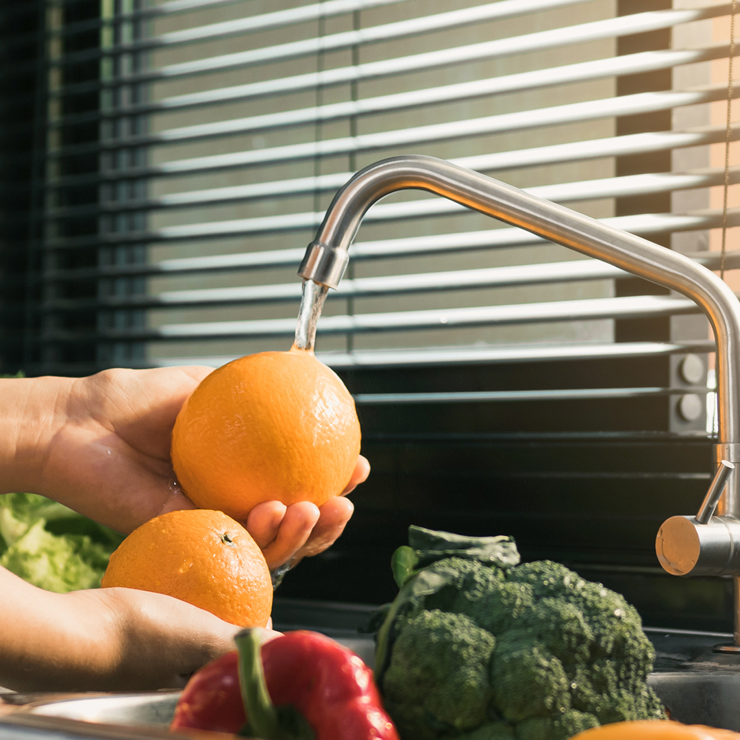 Asian hands woman washing fruit orange and preparation healthy f